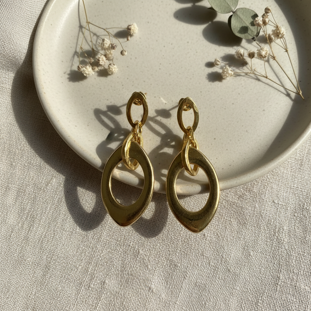 Harakka gold oval earrings flat lay
