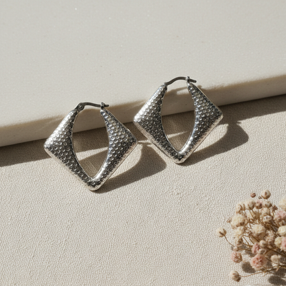 Harakka silver square earrings close-up flat lay