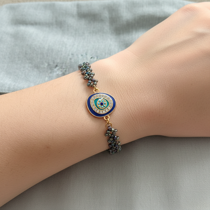 Evil Eye Bracelet - hand-woven metallic bead talisman with enamel decoration